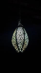 a white christmas ornament hanging from a ceiling at Riad Diafa in Oulad Akkou