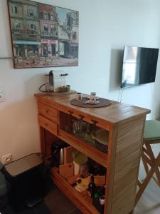 a wooden desk with a sink in a room at Agréable logement à Loches in Loches