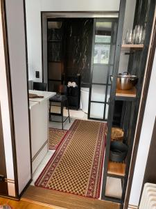 a kitchen with a door open to a room with a table at Karula Stay - 2 Bedroom City Centre Apartment in Antsla