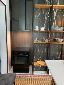 a kitchen with a black wall with a stove at Karula Stay - 2 Bedroom City Centre Apartment in Antsla +6 photos