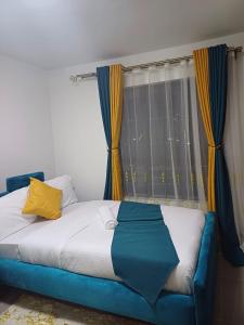 Postel nebo postele na pokoji v ubytování Phemy Homes