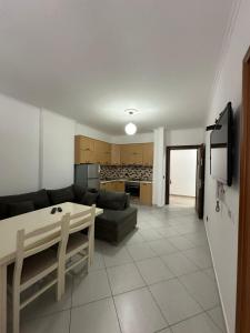 a living room with a couch and a table at Summer Apartments in Shengjin in Shëngjin