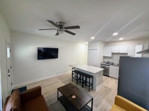 a living room with a ceiling fan and a kitchen at Newly Renovated 2 Bedroom - B in Durham