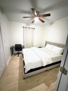 a bedroom with a bed and a ceiling fan at Newly Renovated 2 Bedroom - B in Durham