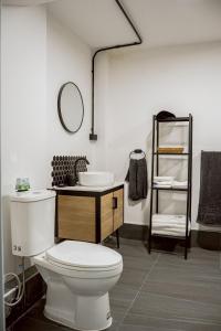 a bathroom with a white toilet and a sink at Oasis Suites Pattaya in Pattaya Central