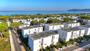 an aerial view of a city with white buildings and the ocean at Holiday Apartment in San Pietro Residence 304 in Lalzit Bay