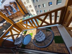 an overhead view of two chairs on a balcony at Apartman D346 u sklopu Aparthotel Vučko in Jahorina