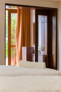 a bedroom with two beds and a large mirror at M1 Szekér Csárda Hotel és Étterem in Obarok