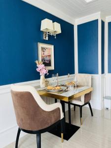 une salle à manger avec une table et un mur bleu dans l'établissement Grand Florida Beachfront Pattaya, à Na Jomtien