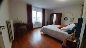 a bedroom with a large bed and a window at Grande maison Lorraine in Vacqueville +6 photos