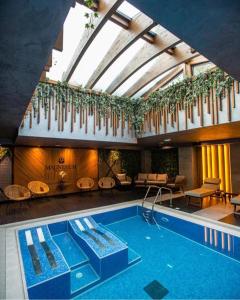 a swimming pool in a building with a ceiling at Lux Apartman Sueno Zlatibor in Zlatibor