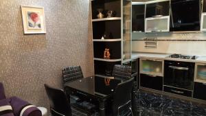 a dining room with a table and chairs at Batumi Flat in Itʼkhvisi