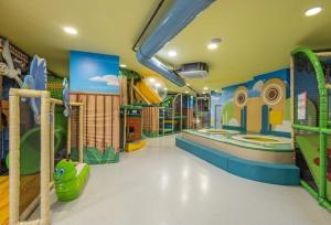 a childrens play room with a playground and slides at Lux Apartman Sueno Zlatibor in Zlatibor