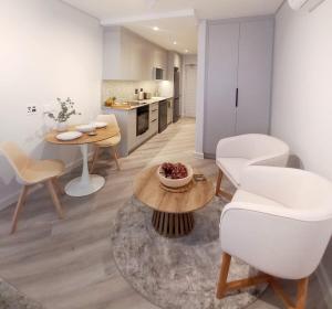 a kitchen and living room with a table and chairs at Platform 133 2 Tabak in Paarl