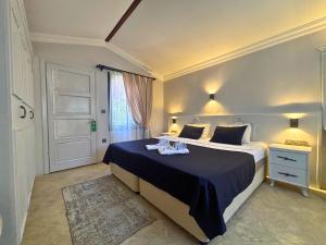 a bedroom with a large bed with a blue blanket at B&B Boutique Hotel in Dalyan +37 photos
