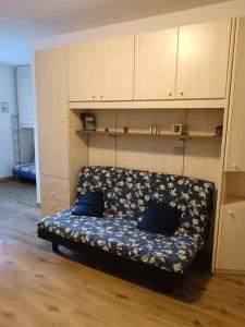 un sofá con almohadas azules sentado en una habitación en Val di Luce Home, en Abetone
