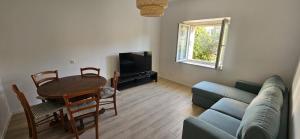 a living room with a blue couch and a table at Suzy apartment, Dugi Rat in Dugi Rat