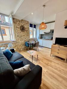 a living room with a couch and a table at petit nid au coeur du Vieux Lyon in Lyon