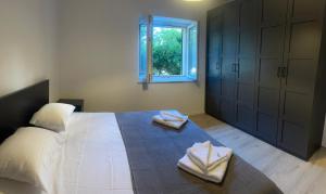 a bedroom with a bed with two towels on it at Suzy apartment, Dugi Rat in Dugi Rat