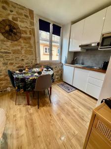 a kitchen with a table in a kitchen with a dining room at petit nid au coeur du Vieux Lyon in Lyon