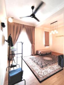 a living room with a bed and a ceiling fan at The White House Nilai Impian in Nilai