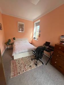 a bedroom with a bed and a desk and a chair at Seven Sisters 1 bed apartment in Moffat