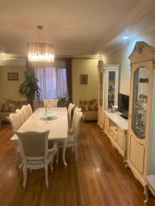 a dining room with a white table and chairs at Yerevan Guesthouse B&B in Yerevan