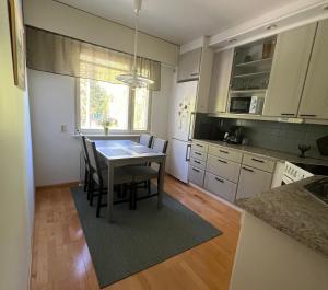 a kitchen with a table and chairs in a kitchen at Cityflat by Travel Center in Lappeenranta
