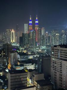a view of a city at night with at Chamber Luxury suites pwtc At KLCC in Kuala Lumpur