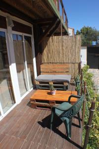 a wooden deck with a bench and a table at Casa Tacande del Valle in Santiago del Teide