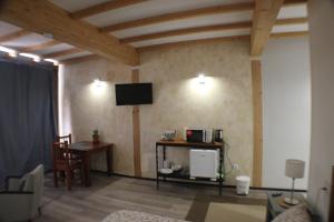 a living room with a tv and a table with a chair at Casa Tacande del Valle in Santiago del Teide
