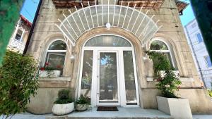 an entry to a building with a white door at Romantic central apartment in Constanţa