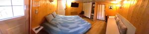 a bedroom with a bed in the corner of a room at Chambre d'hôte chez Nathalie & Roland in Massiac
