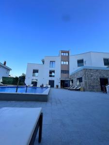 a view of a building with a swimming pool at Blue Haven apartment 2 in Tušupi