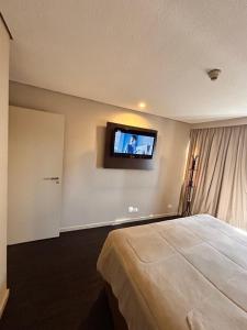 Кровать или кровати в номере Jardim Berrini