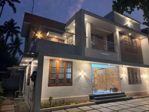 a house is lit up at night at Tranquil Home in Trivandrum