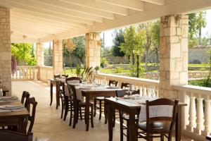 a restaurant with tables and chairs on a patio at I Giardini del Melograno in Ruvo di Puglia