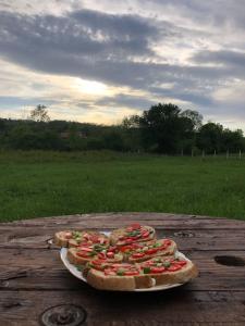 a plate with four pizzas on a wooden table at Casa Roua in Baile Felix