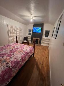 a bedroom with a bed and a tv on a wall at Downtown Neighborhood Room 1 in Phoenix