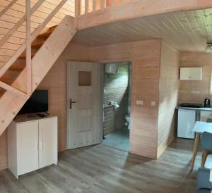 a large room with a staircase and a kitchen in a house at Apartamenty Cztery Siostry in Zastań +38 photos