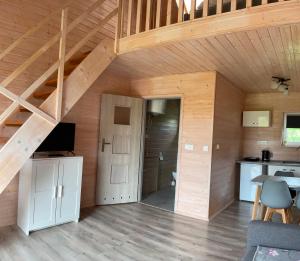 a room with a staircase in a wooden house at Apartamenty Cztery Siostry in Zastań