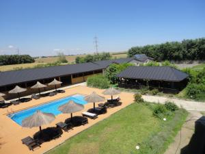 an overhead view of a resort with a swimming pool and umbrellas at Greenstone Land - Corbu in Năvodari