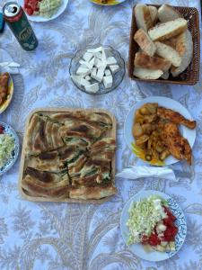 a table with different types of food on it at Alpet in Vusanje +41 photos