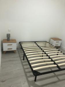a bedroom with a bed and a dresser and a bed frame at appt 10 couchages tt confort appt 3 in Laveissière