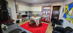 a small kitchen with a table in a room at Casa Canto do Farol in Navegantes