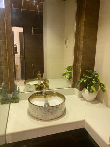 un baño con lavabo y dos espejos en hotel milton, en Islamabad