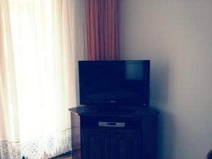 a flat screen tv sitting on top of a black stand at Apartment Pejic in Umag