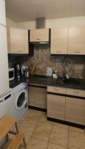 a kitchen with a sink and a washing machine at Rommi Kodumajutus in Pärnu +11 photos
