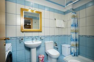 a bathroom with a sink and a toilet and a mirror at Apartments Vlora Holidays in Vlorë +25 photos