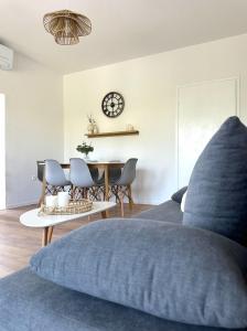 a bedroom with a bed and a table with chairs at Adria Apartment in Spodnje Škofije